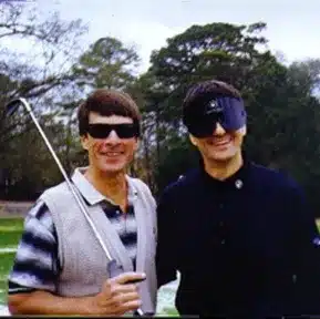 Charles Kallassy teaching blind golfer Bob Andrews