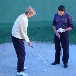 Charles Kallassy working on bunker shots with LPGA Master Professional Dana Rader