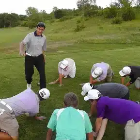 Charles Kallassy teaching a junior golf clinic