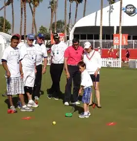 Charles Kallassy and Lorena Ochoa teaching beginning golfers at the Kraft Nabisco LPGA Championship