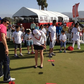 Charles Kallassy teaching children with Lorena Ochoa