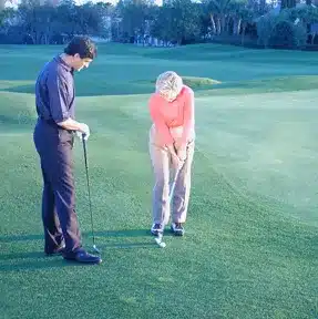 Charles Kallassy working on chip shots with Sandra Palmer